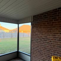 Screened porch with brick accent wall